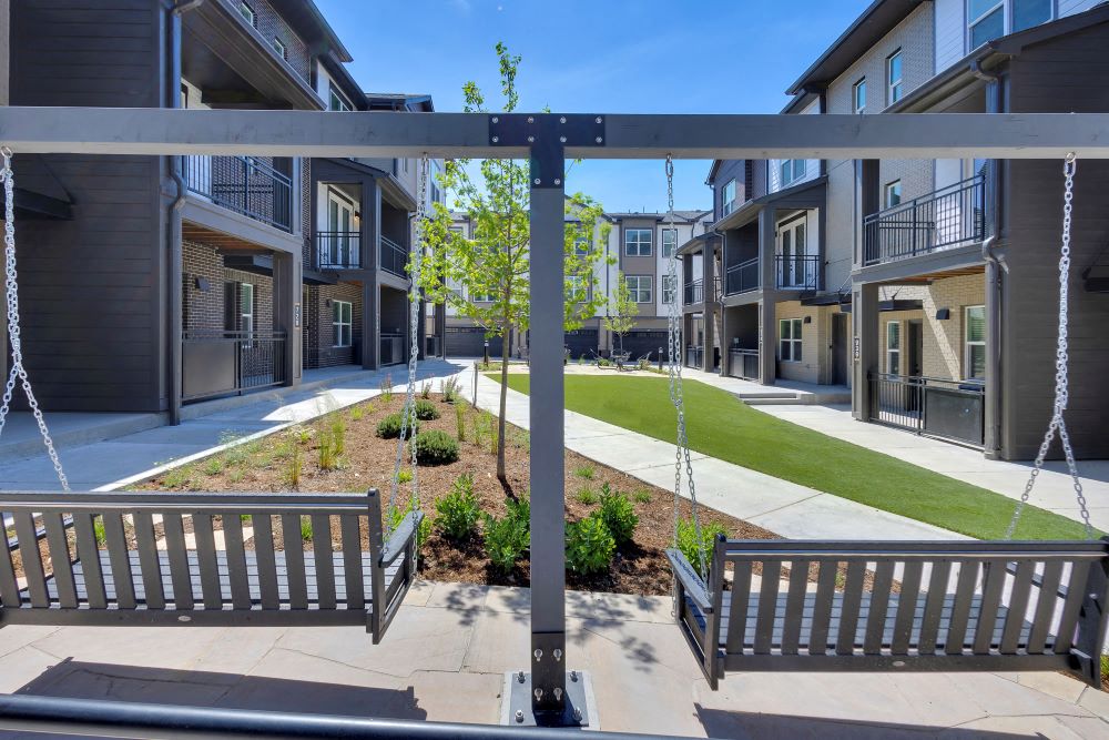 Two outdoor swings overlooking the courtyard between